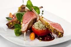 Roasted Lamb Chops with Pistachio. Garnished with Vegetables and Basil